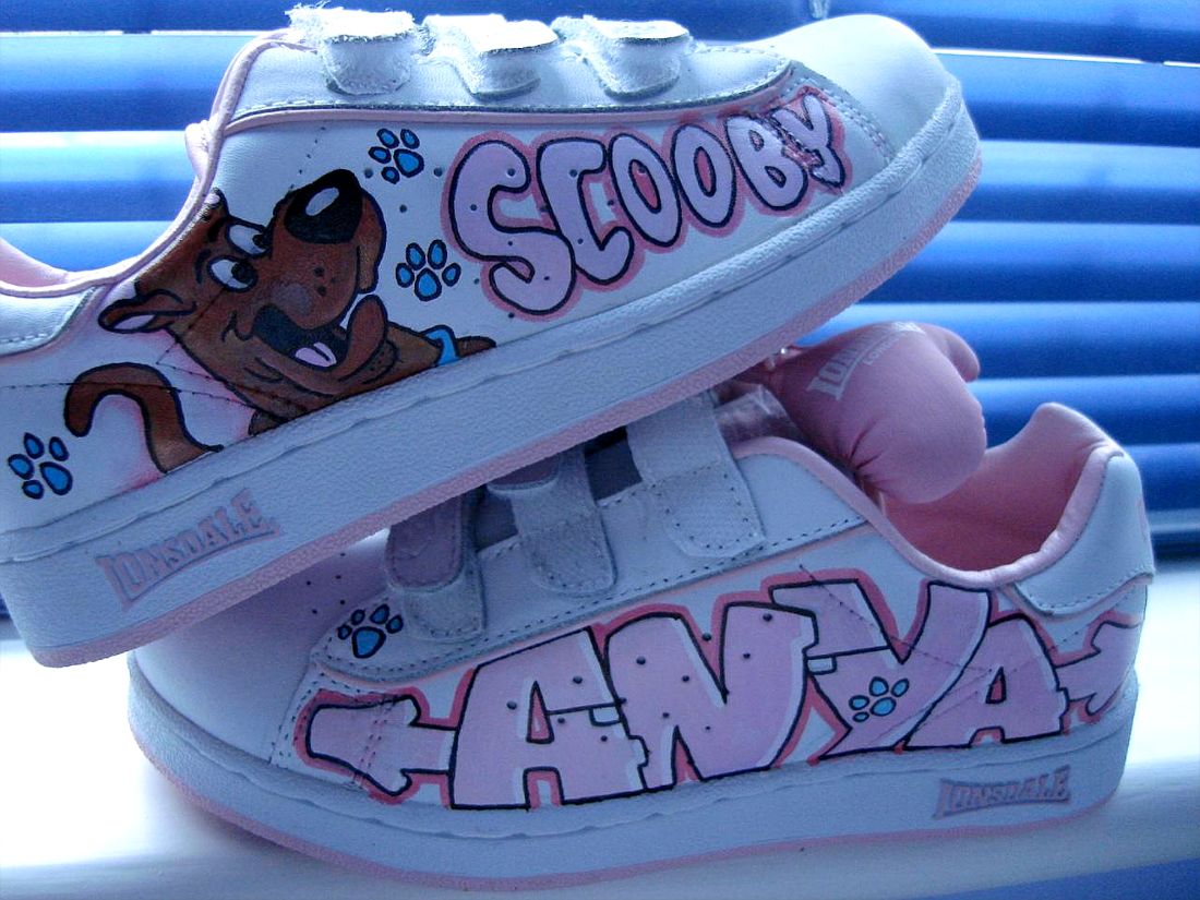 Hand-painted custom kids' trainers drying in the BUBBLEHOPS studio